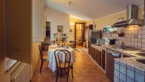 a kitchen with a table with chairs and a stove at Villa Nuba,con private SPA room in Perugia