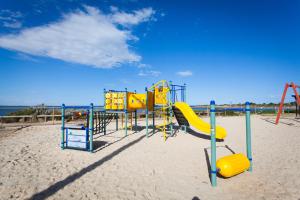 an empty playground on the beach at Modra's Apartments in Tumby Bay