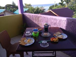 a table with plates of food on a balcony at pulau weh sabang marifi in Paya