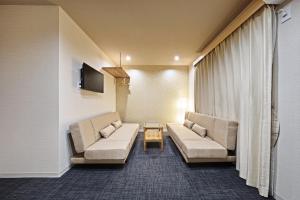 a living room with two couches and a table at Stay SAKURA Kyoto Higashiyama Shirakawa in Kyoto