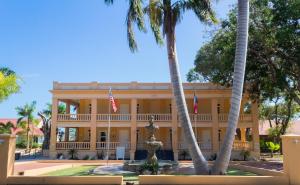 a large building with palm trees in front of it at Parador Guánica 1929 in Guanica