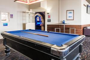 a pool table in the middle of a room at Somerset Hotel in Somerset