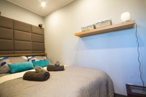a bedroom with a bed with two stuffed animals on it at Apartament Attico in Kowary +20 photos