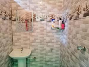 a bathroom with a sink and a mirror at NAZ Homestay in Jitra