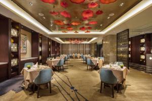 a restaurant with tables and chairs and a ceiling with flowers at Wyndham Shanghai Nanxiang in Jiading