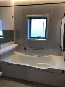 a large bath tub in a bathroom with a window at Kaen in Tachikawa +55 photos