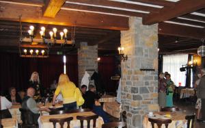 a group of people sitting at tables in a restaurant at Hotel Beco in Banneux