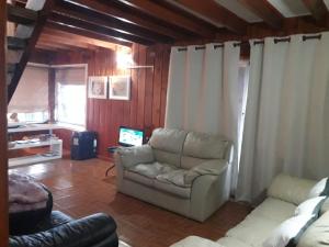 a living room with a couch and a chair at Eco Nautic Hostel in Valdivia