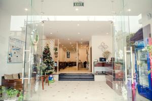 a christmas tree in the entrance to a store at Gardenia Hue Hotel in Hue