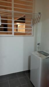 a kitchen with a washing machine and a window at AZ Homestay @ Southville City in Bangi