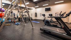 a gym with a treadmill and a lot of exercise equipment at The Prussia Hotel, BW Signature Collection in King of Prussia