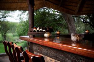 a wooden table with eggs on it with chairs at Idube Game Reserve in Sabi Sand Game Reserve