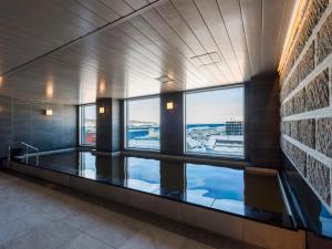 a room with a large window in a building at Hotel Sonia Otaru in Otaru