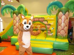 a person dressed in a fox costume in front of a play set at Wellness Hotel Gyula in Gyula