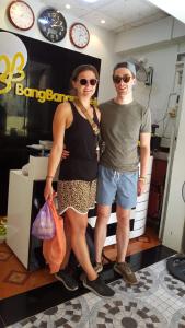 a man and a woman standing in front of a store at BangBang Motel in Can Tho
