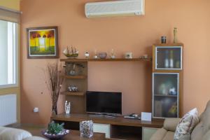 un salon avec une télévision et un canapé dans l'établissement Larnaca Villa Anthea 12, à Larnaka