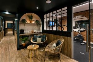 a salon with two chairs and a table at Royal Madeleine Hotel & Spa in Paris