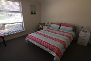 a bedroom with a bed and a window at 19 Georgian Court in Bright