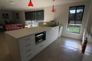 a kitchen with white cabinets and a counter top at 19 Georgian Court in Bright