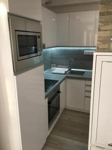 a kitchen with a sink and a microwave at Rose Central Apartment in Debrecen