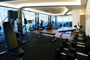 a gym with treadmills and machines in a building at Holiday Villa Johor Bahru City Centre in Johor Bahru