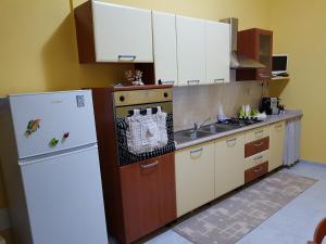 a kitchen with a refrigerator and a sink in it at Sweet Home in Floridia