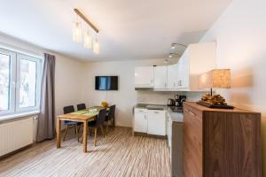 a kitchen with a table and a dining room at RentPlanet - Apartament Czecha in Świeradów-Zdrój