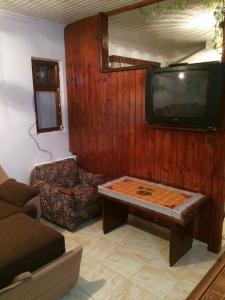 a living room with a tv and a couch and a coffee table at Vasile Alecsandri 60 ap 49 in Chişinău