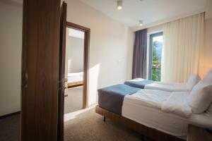 Voodi või voodid majutusasutuse AuRoom Bakuriani Resort toas