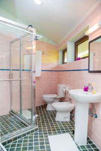 a bathroom with two toilets and a sink and a shower at Cap-sud self catering in Au Cap