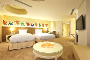 Postel nebo postele na pokoji v ubytování Green World Hotel - Zhonghua