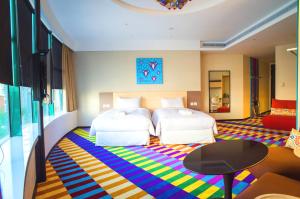 Postel nebo postele na pokoji v ubytování Green World Hotel - Zhonghua