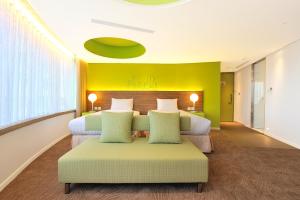 Postel nebo postele na pokoji v ubytování Green World Hotel - Zhonghua