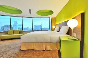 Postel nebo postele na pokoji v ubytování Green World Hotel - Zhonghua