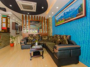 a living room with couches and a table at Hotel Lakeside Pvt. Ltd. in Pokhara
