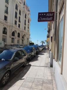 a street with cars parked on the side of a building at Hotel Cronstadt in Nice