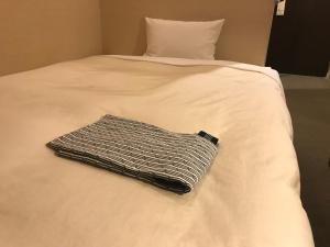 En eller flere senge i et værelse på Business Hotel Goi Hills
