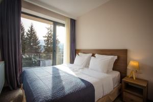 Voodi või voodid majutusasutuse AuRoom Bakuriani Resort toas