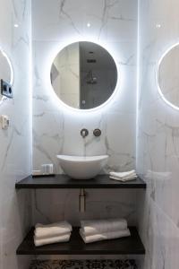 a white bathroom with a sink and a mirror at The Blossom House Amsterdam in Amsterdam