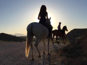 duas pessoas a cavalo numa estrada de terra batida em Hotel Rural Valle del Turrilla - Cazorlatur em Hinojares