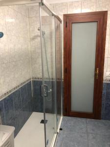 a shower with a glass door in a bathroom at Islas Malvinas 39 Atico F in Vecindario