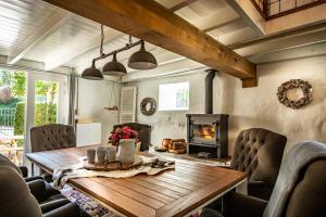 a dining room with a wooden table and a fireplace at Vakwerkloft in Valkenburg