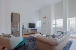 a living room with a couch and two chairs at Liiiving in Porto | Aliados Luxury Apartments in Porto