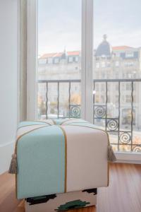 a suitcase sitting in front of a window at Liiiving in Porto | Aliados Luxury Apartments in Porto