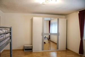 a bedroom with a sliding glass door with a mirror at Ferienwohnung Prinz-Kari in Stühlingen