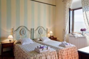 Postel nebo postele na pokoji v ubytování Agriresort & Spa Fattoria I Ricci