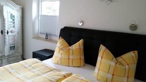 a bedroom with a bed with two pillows on it at Ferienhaus Eichhorn in Breege