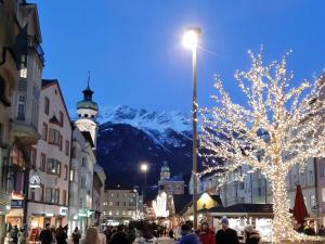 a street with a christmas tree and a mountain at Charming, central, spacious apartment in Innsbruck
