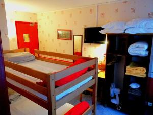 a bedroom with two bunk beds and a tv at Le relais du Haut Limousin in Eymoutiers