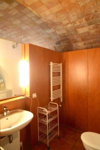 a bathroom with a sink and a toilet and a shelf at Casa Flora - Cadaqués in Cadaqués